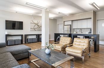 a living room with couches and chairs and a table with a vase on it